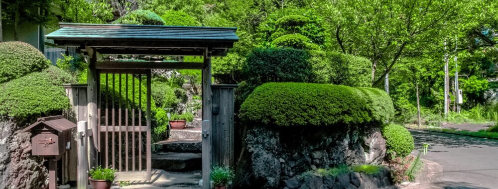 wooden gate leading to a lush garden